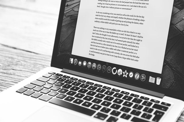 Writing a blog post on a laptop